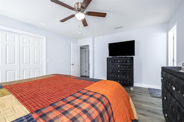 bedroom featuring dark hardwood / wood-style flooring, a closet, and ceiling fan