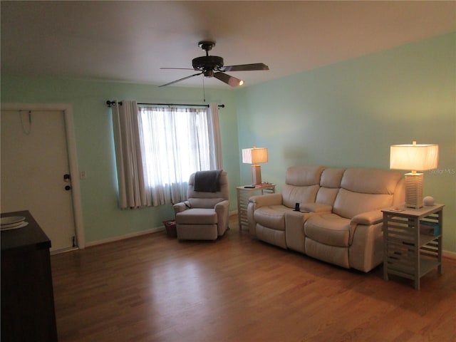 living room with hardwood / wood-style floors and ceiling fan