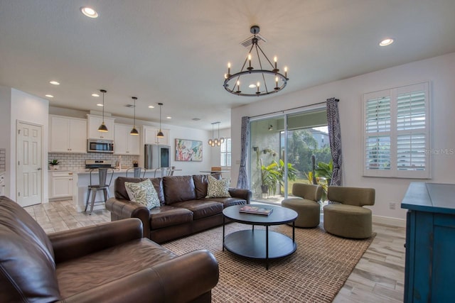 living room featuring a notable chandelier and light hardwood / wood-style flooring