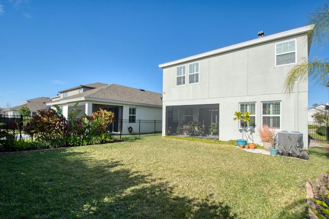 back of house featuring a sunroom and a yard