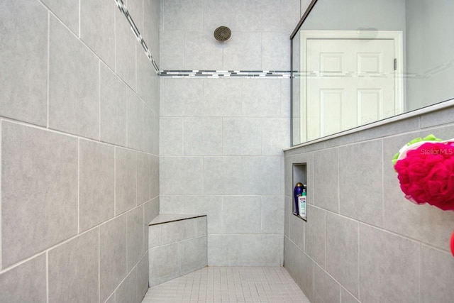 bathroom with a tile shower