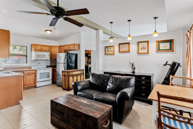 living room featuring lofted ceiling, sink, light tile patterned floors, and ceiling fan