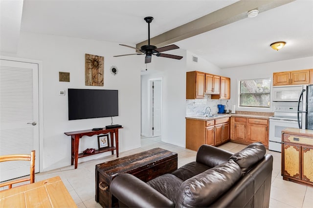 living room featuring lofted ceiling with beams, ceiling fan, sink, and light tile patterned floors