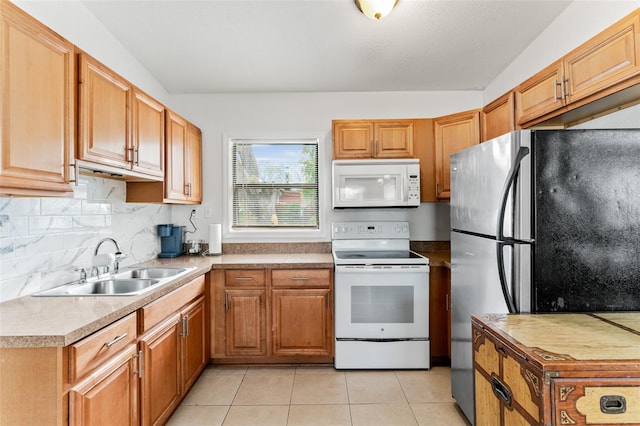 kitchen featuring tasteful backsplash, sink, white appliances, and light tile patterned flooring