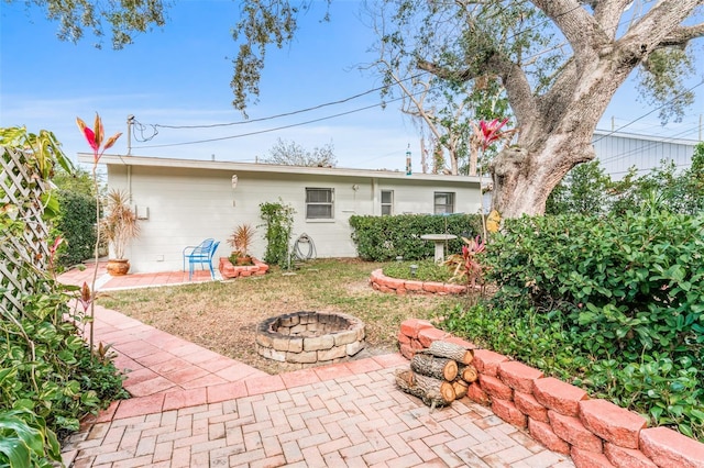 back of house featuring a patio and an outdoor fire pit