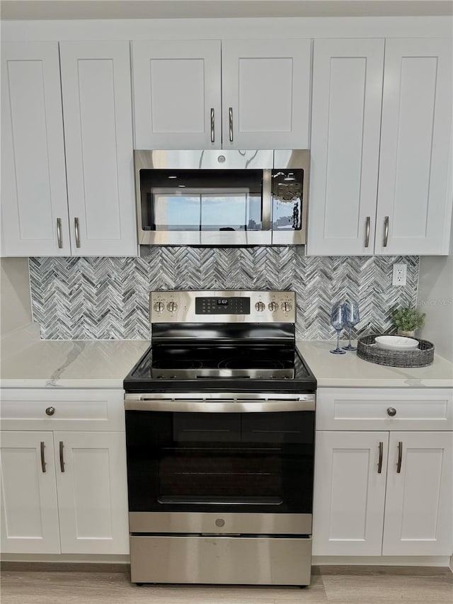 kitchen featuring white cabinetry, tasteful backsplash, and appliances with stainless steel finishes