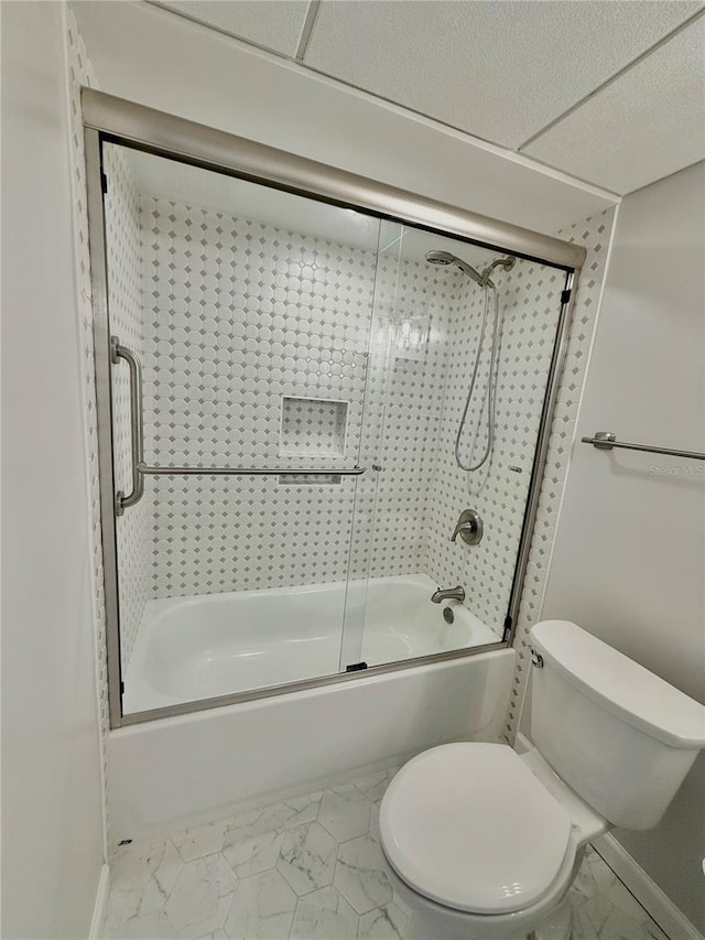 bathroom featuring toilet and combined bath / shower with glass door