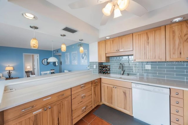 kitchen featuring dishwasher, sink, decorative backsplash, hanging light fixtures, and kitchen peninsula