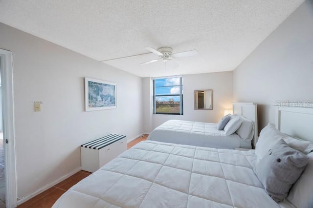 bedroom featuring a textured ceiling and ceiling fan