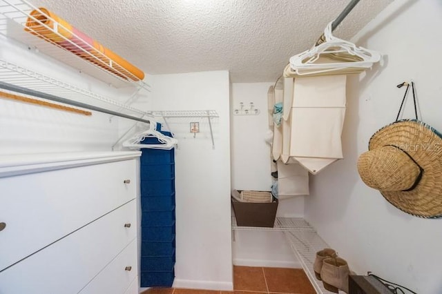 walk in closet with tile patterned floors