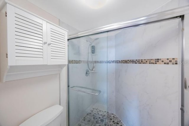 bathroom with walk in shower and toilet