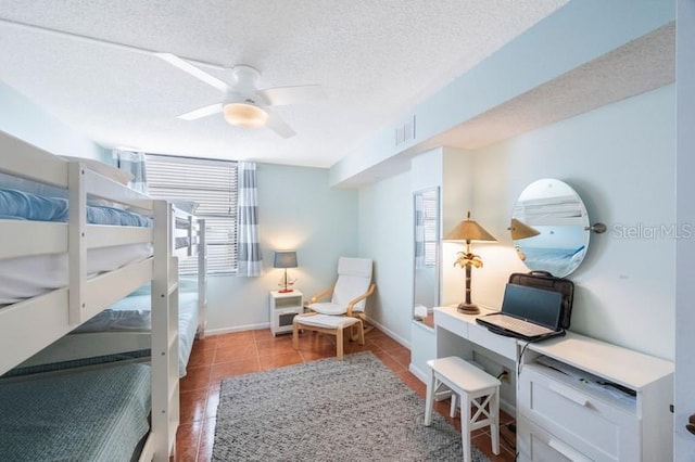 bedroom featuring light tile patterned floors, a textured ceiling, and ceiling fan