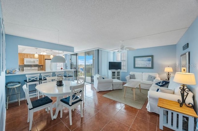 6051 Sun Blvd Unit 504, Saint Petersburg, FL 33715 - dining space featuring dark tile patterned floors, a textured ceiling, ceiling fan, and expansive windows