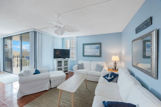 6051 Sun Blvd Unit 504, Saint Petersburg, FL 33715 - tiled living room featuring ceiling fan, floor to ceiling windows, and a textured ceiling