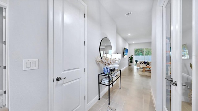 hallway with light tile patterned floors