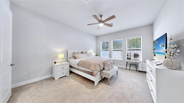 bedroom with ceiling fan and light carpet