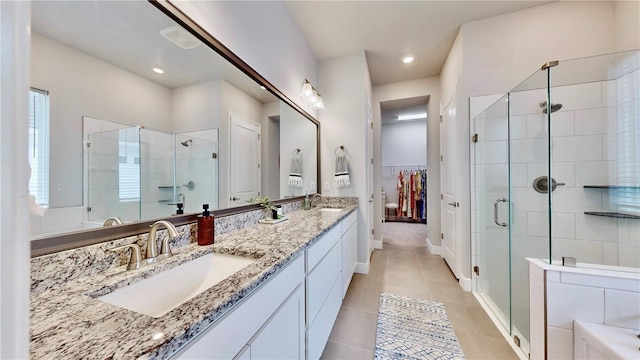 bathroom with tile patterned flooring, vanity, and an enclosed shower