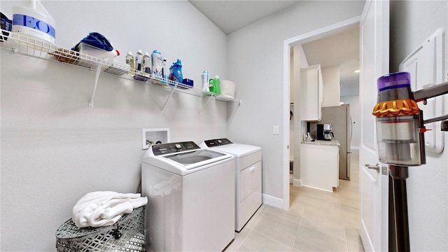 washroom featuring light tile patterned flooring and washer and clothes dryer