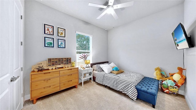 bedroom featuring lofted ceiling, light colored carpet, and ceiling fan