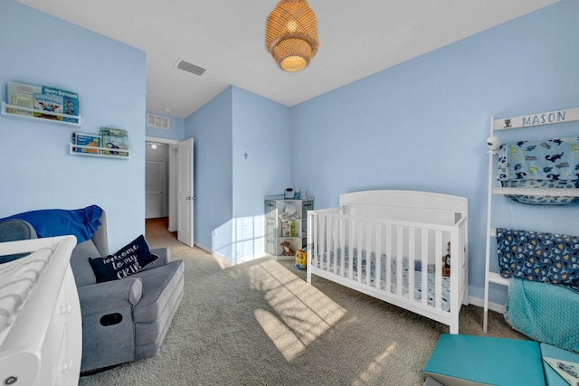 bedroom featuring carpet flooring and a crib