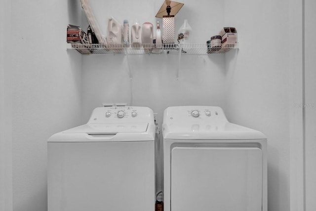 washroom with washing machine and clothes dryer