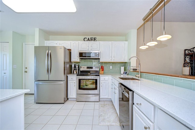 kitchen featuring white cabinetry, appliances with stainless steel finishes, sink, and hanging light fixtures