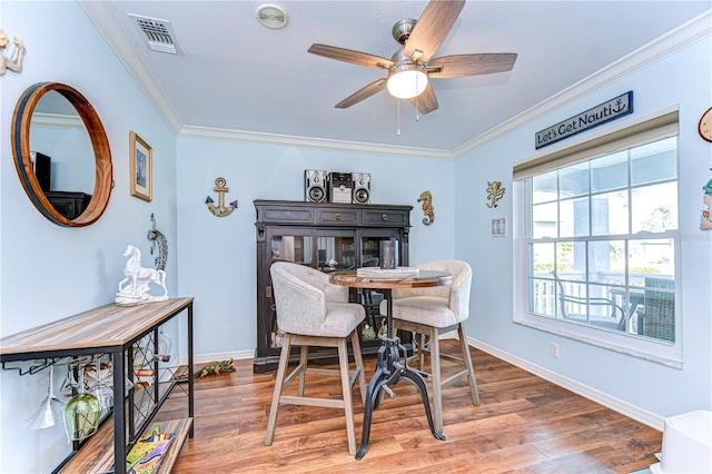 dining area featuring ornamental molding, hardwood / wood-style floors, and ceiling fan