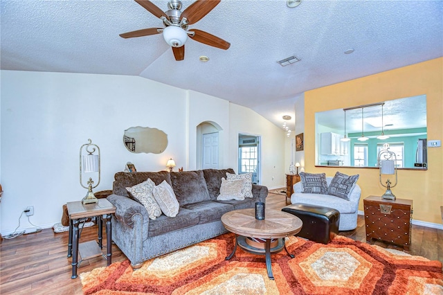 living room featuring hardwood / wood-style flooring, a textured ceiling, and a wealth of natural light