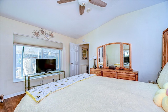 bedroom featuring dark hardwood / wood-style flooring, vaulted ceiling, and ceiling fan