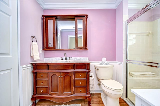 bathroom with wood-type flooring, vanity, an enclosed shower, toilet, and crown molding