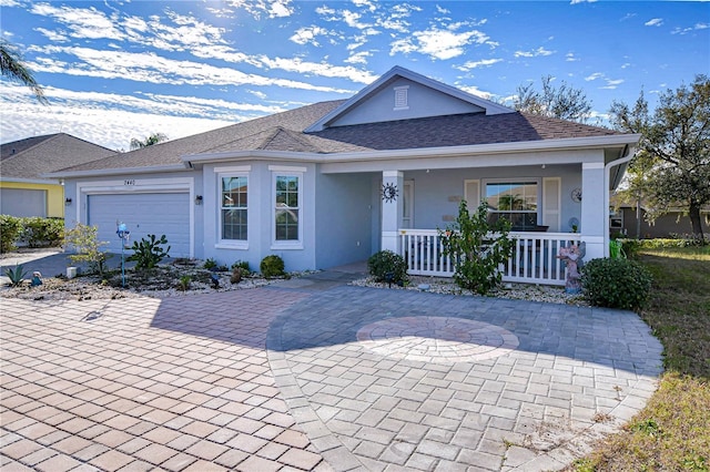 ranch-style home with a garage and covered porch