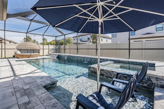 view of pool with a lanai, a patio area, and an in ground hot tub