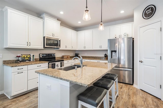 kitchen with white cabinetry, appliances with stainless steel finishes, and sink