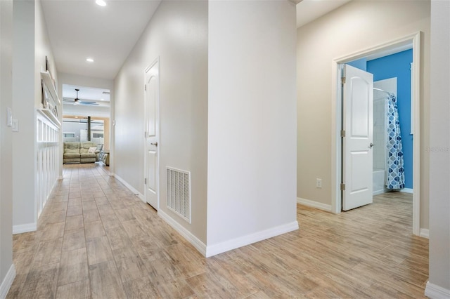 corridor with light hardwood / wood-style floors