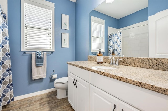 bathroom featuring vanity, plenty of natural light, a shower with shower curtain, and toilet