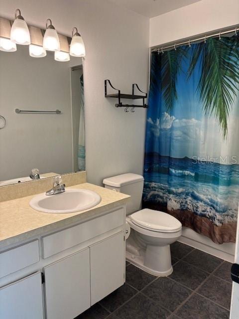 full bath with toilet, tile patterned floors, shower / bath combo with shower curtain, and vanity