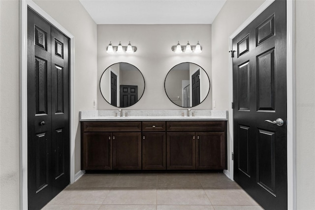 bathroom featuring tile patterned flooring and vanity