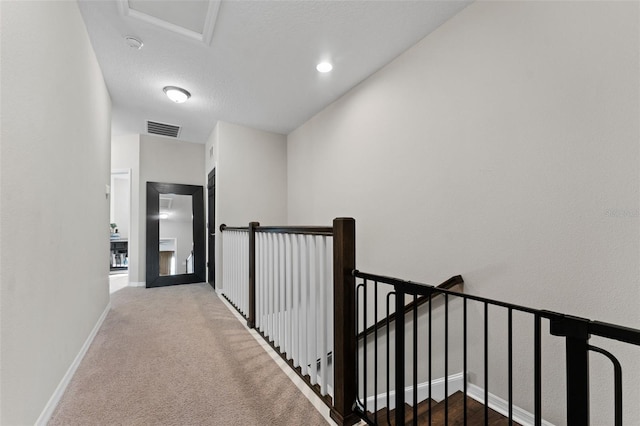 hallway with carpet floors