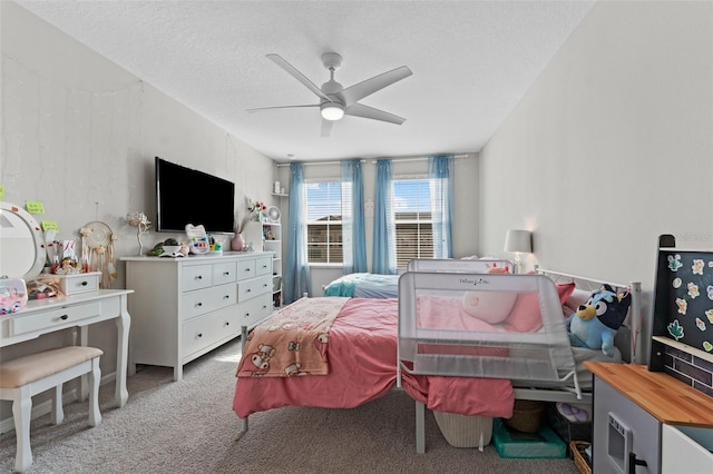 carpeted bedroom featuring ceiling fan and a textured ceiling