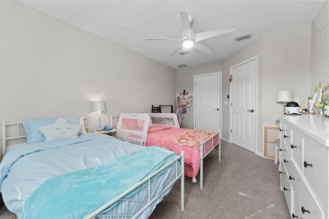 bedroom with light colored carpet, a textured ceiling, and ceiling fan