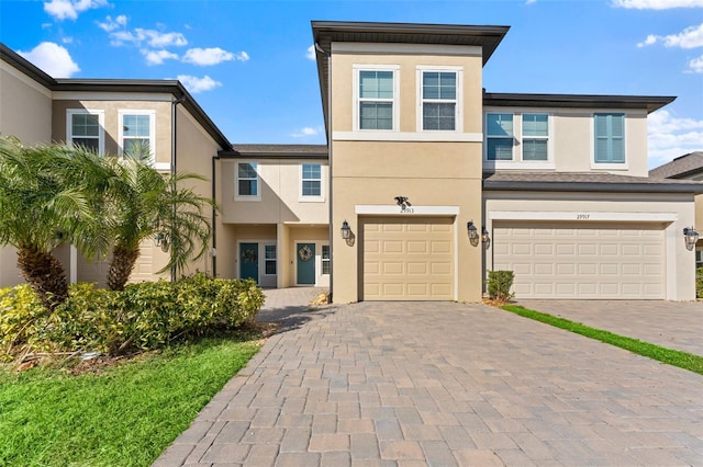 29913 Southwell Ln, Wesley Chapel, FL 33543 - view of front of home with stucco siding, decorative driveway, and a garage