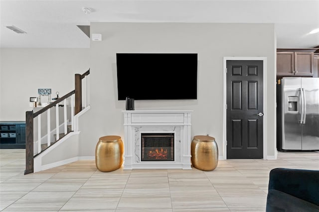 29913 Southwell Ln, Wesley Chapel, FL 33543 - living room with stairway, light tile patterned floors, a premium fireplace, and baseboards