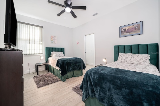 bedroom with ceiling fan and light hardwood / wood-style flooring