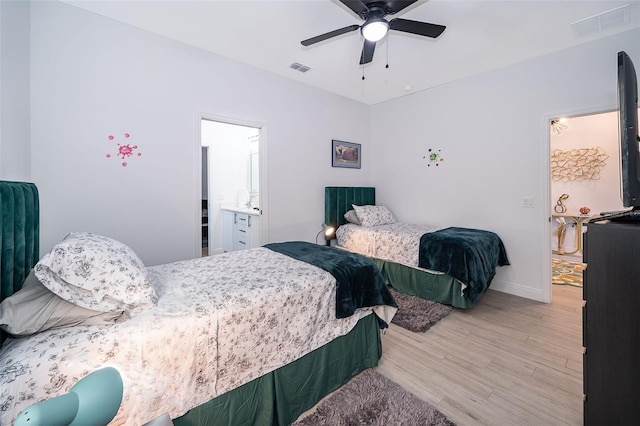 bedroom featuring ensuite bathroom, hardwood / wood-style floors, and ceiling fan