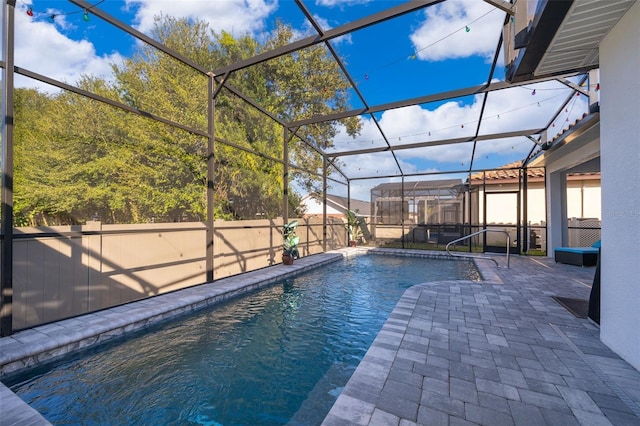 view of pool with a lanai and a patio area