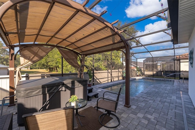 view of swimming pool with a hot tub, a patio area, and a lanai