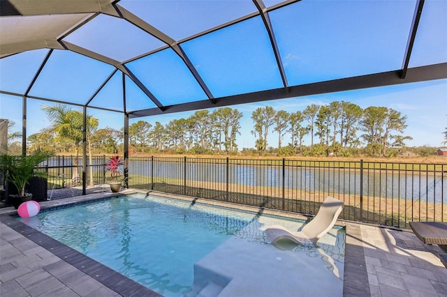 view of swimming pool featuring a water view, a lanai, and a patio area