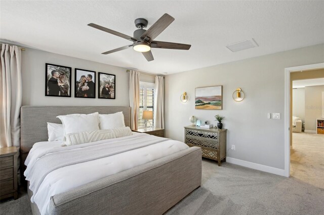 bedroom with a ceiling fan, baseboards, and light carpet