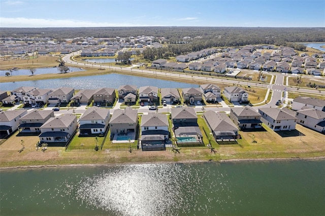 bird's eye view featuring a water view and a residential view