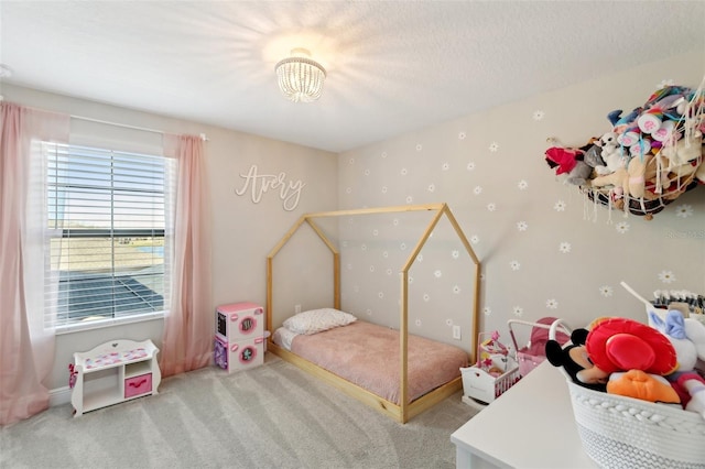 carpeted bedroom featuring a textured ceiling